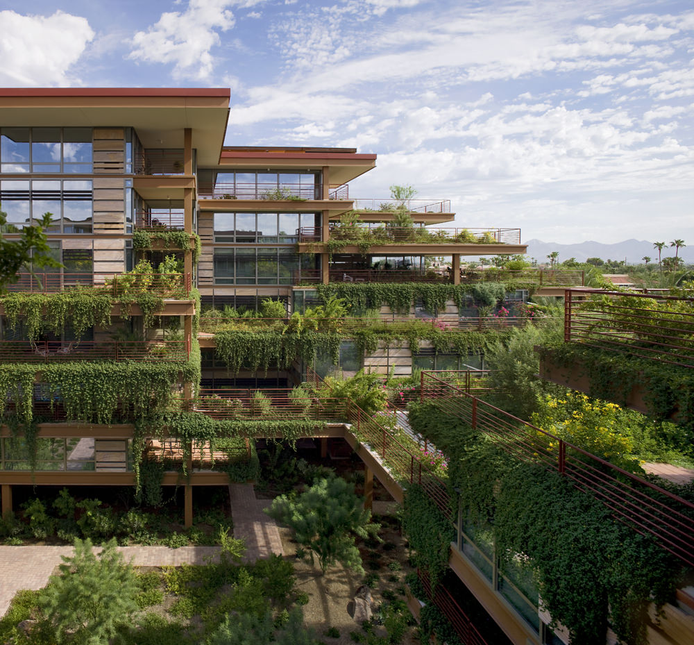 Optima Camelview Village from afar shows balconies lush with greenery and a view of the courtyard.