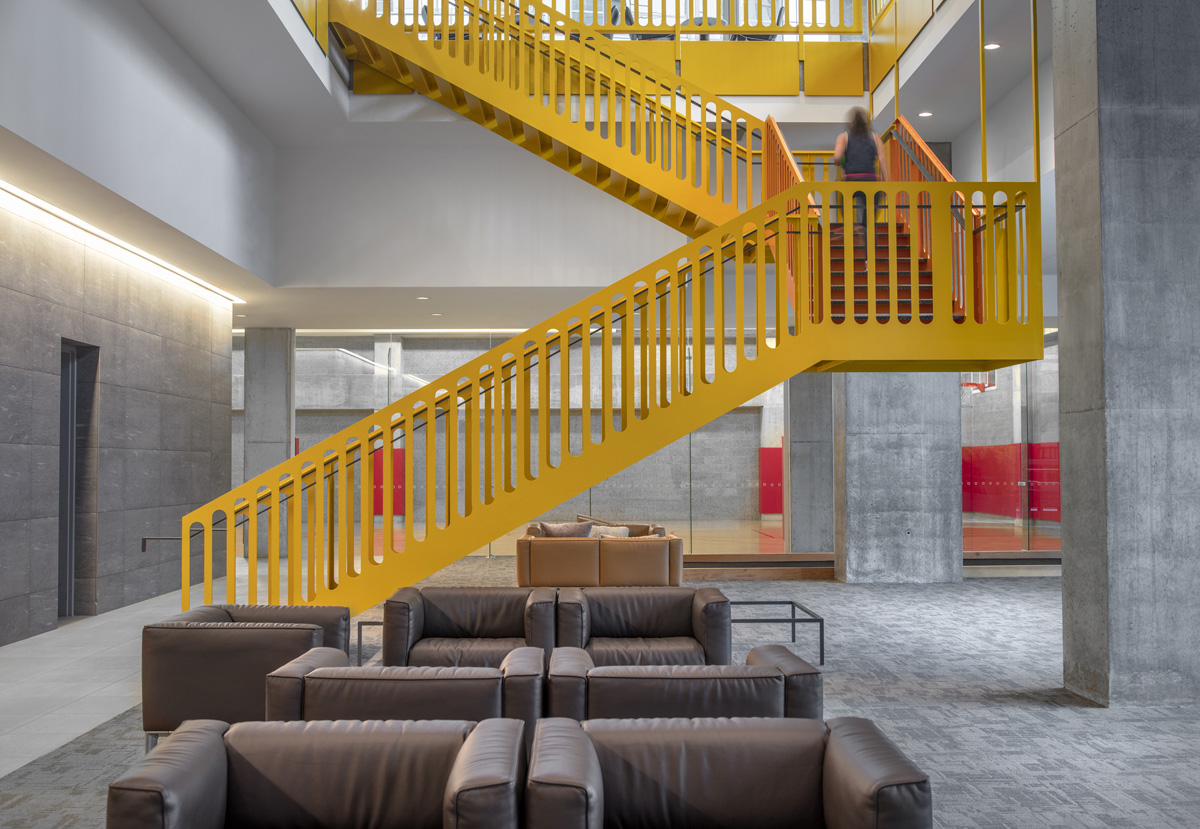 Yellow stairs connecting the amenity floors at Optima Signature