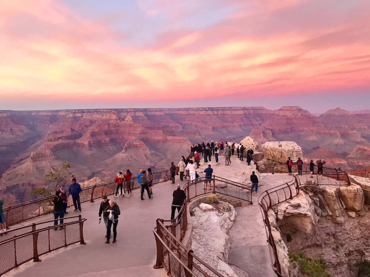 A lookout point in the Grand Canyon while the sunset turns the sky pink